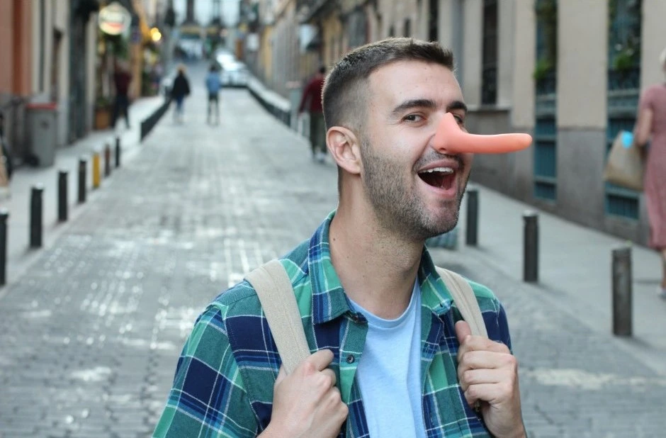 Bugiardo patologico: foto di un ragazzo con un naso di gomma allungato e tratti narcisisti che cammina per la strada con fare compiaciuto, ad evidenziare il profilo psicologico del mentitore compulsivo